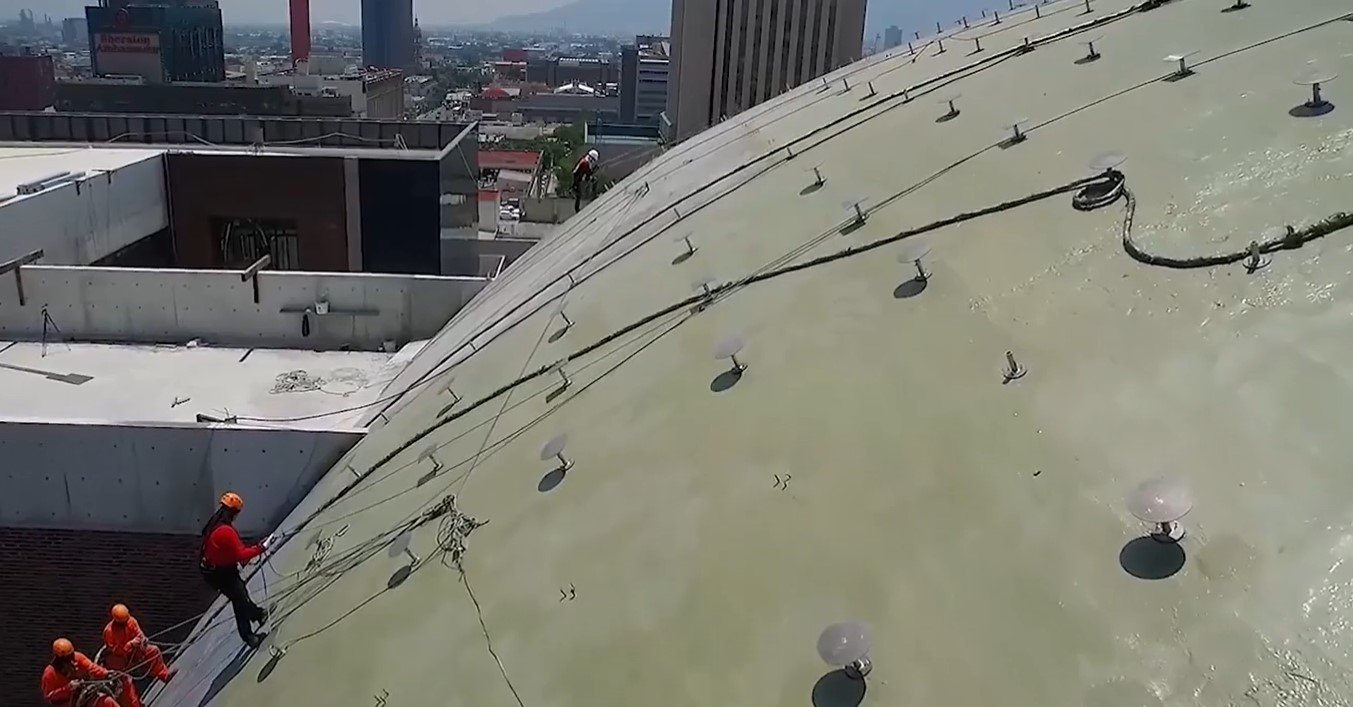 workers polyurea spraying domed roof