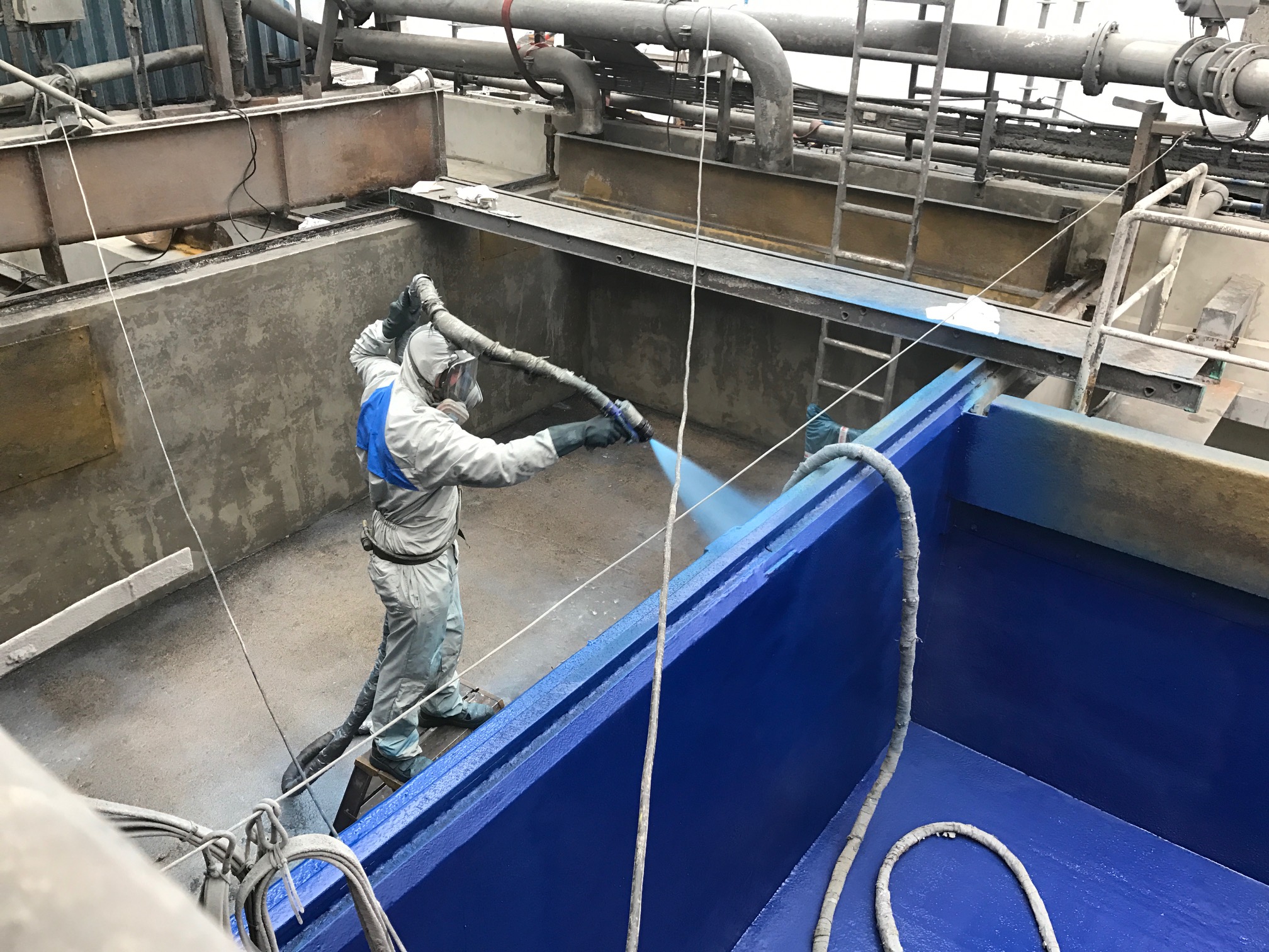 technician applying polyurea to concrete