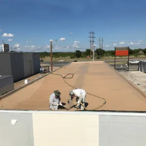 specialists applying polyurea coating to rooftop
